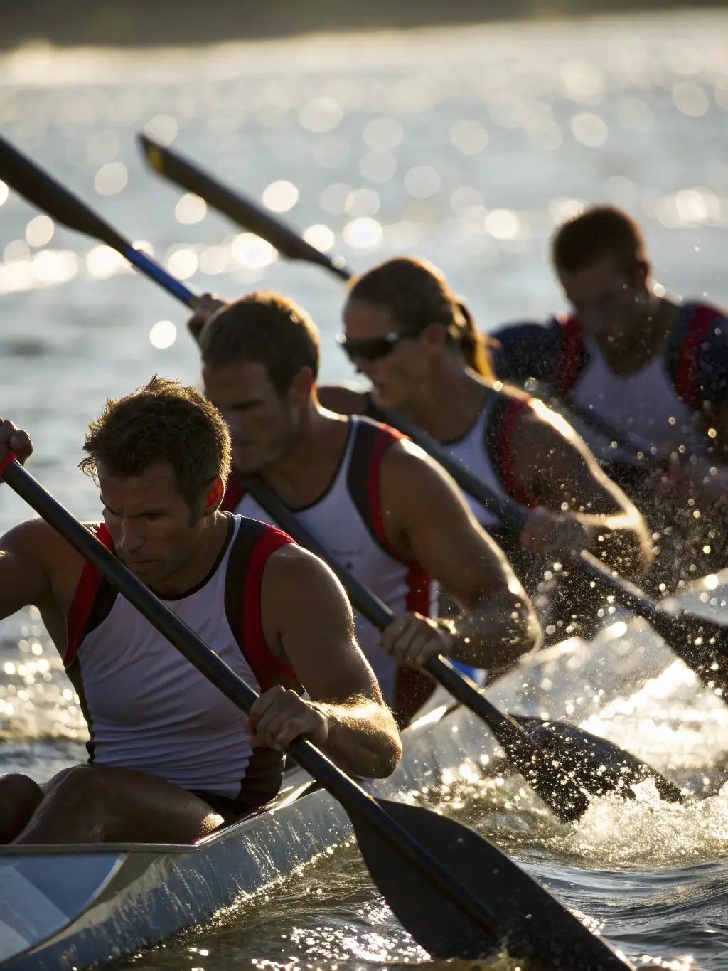 An action shot of experienced rowers participating in a competitive rowing race, showcasing their speed and teamwork.